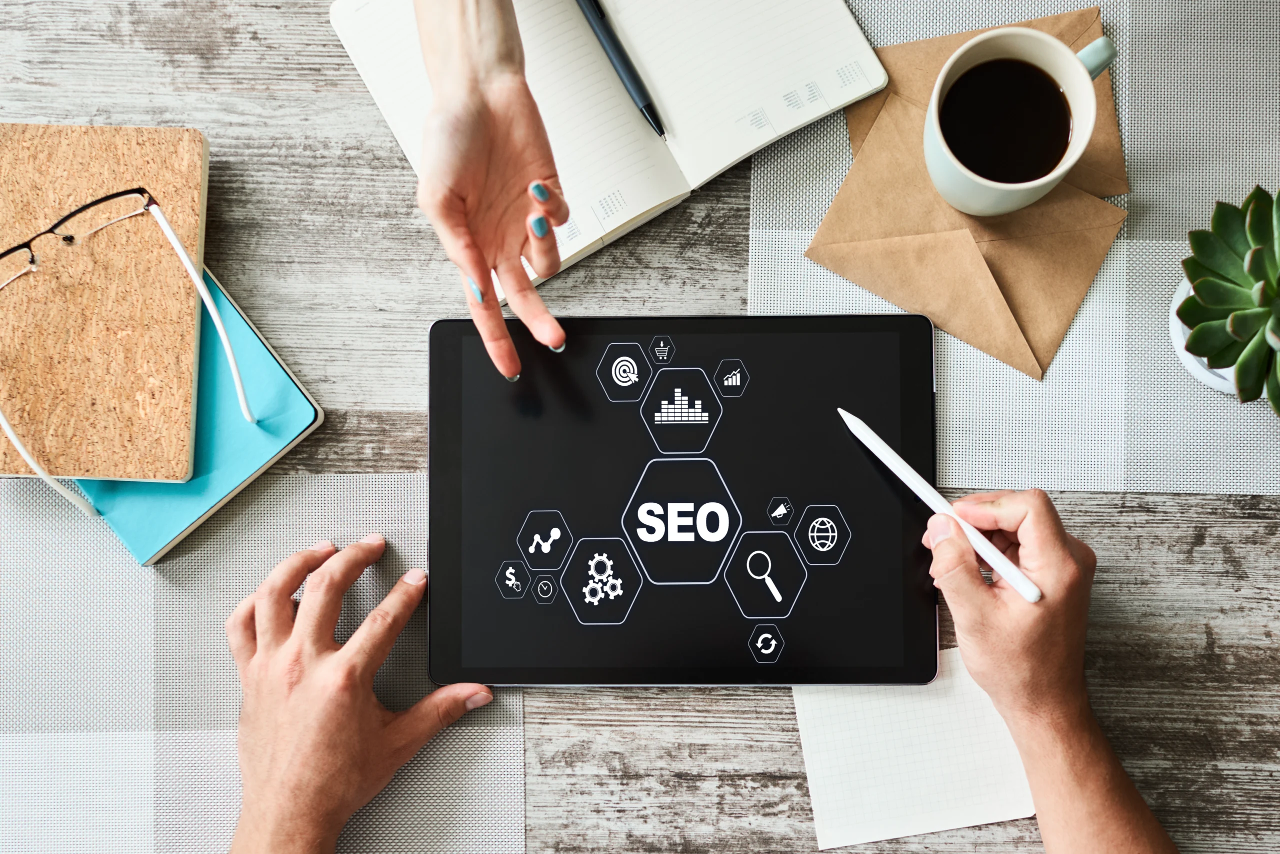 person holding a tablet pencil with SEO graphic on a tablet